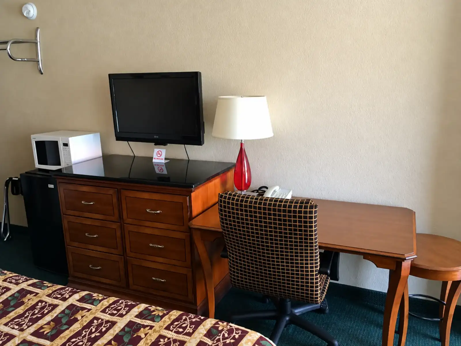 Guest room work desk, television, microwave and refrigerator